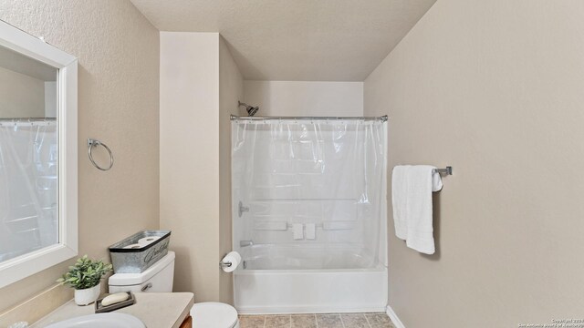 full bathroom featuring toilet, shower / tub combo with curtain, a textured ceiling, and vanity