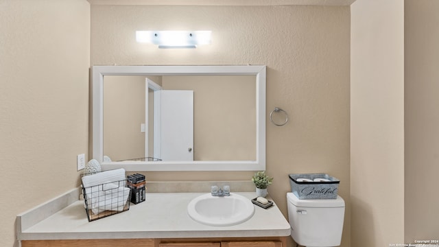 bathroom with toilet and vanity