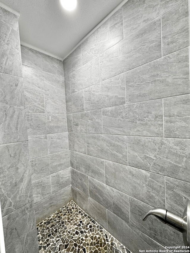 bathroom with a tile shower