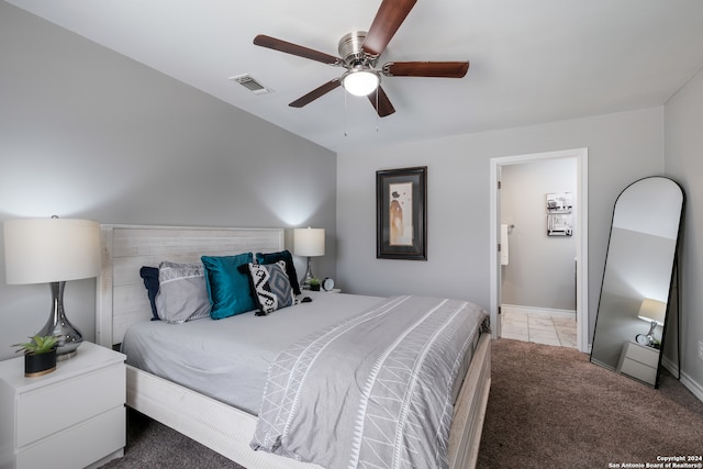 bedroom featuring ceiling fan, ensuite bath, and carpet floors