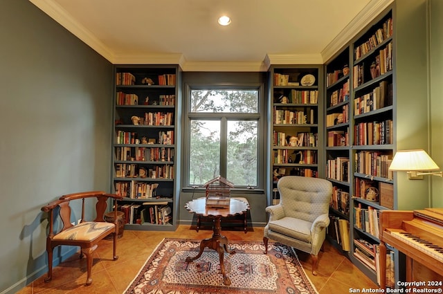 sitting room with ornamental molding and light tile patterned floors