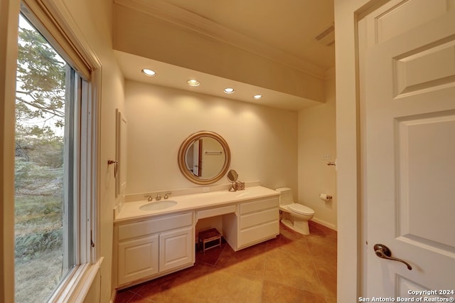 bathroom with tile patterned flooring, vanity, toilet, and crown molding