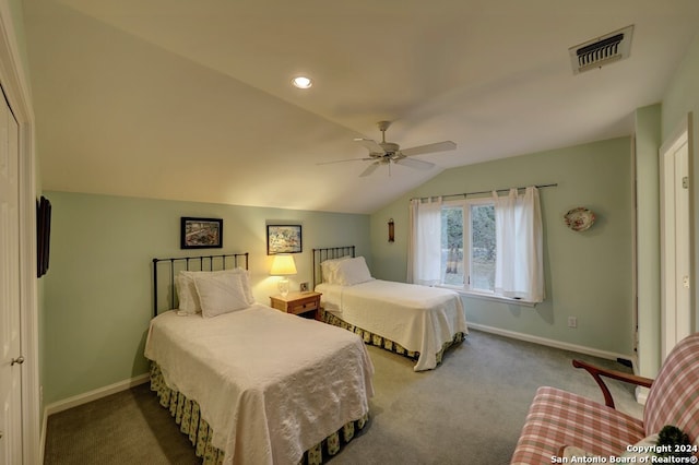 bedroom featuring lofted ceiling, dark carpet, and ceiling fan