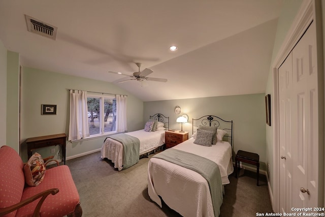 carpeted bedroom with lofted ceiling, a closet, and ceiling fan