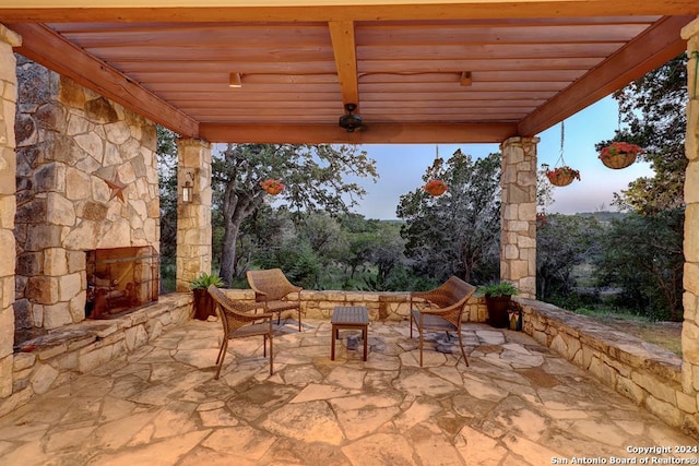 view of patio / terrace featuring a pergola and an outdoor stone fireplace