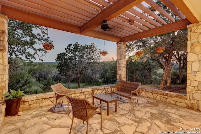 patio terrace at dusk with a pergola