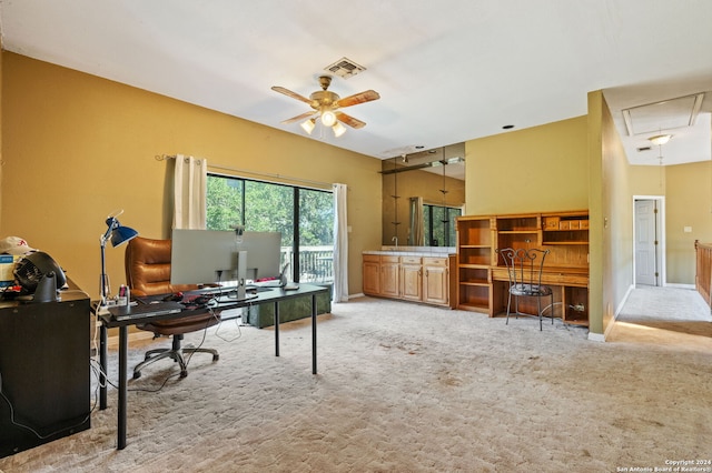 carpeted office space with ceiling fan