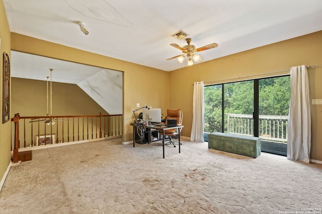 carpeted office space with vaulted ceiling and ceiling fan