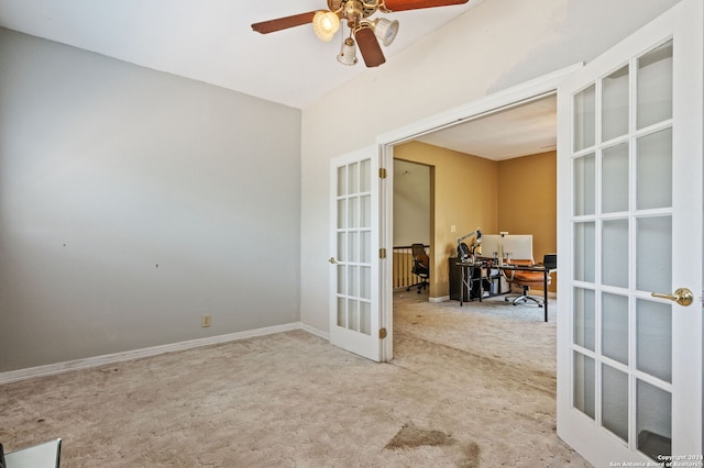 empty room featuring carpet, ceiling fan, and french doors