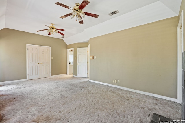 spare room featuring vaulted ceiling, ceiling fan, and carpet