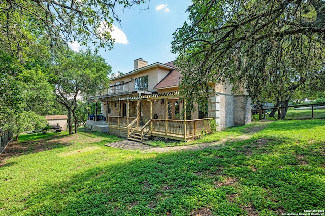 back of property featuring a pergola, a yard, and a wooden deck