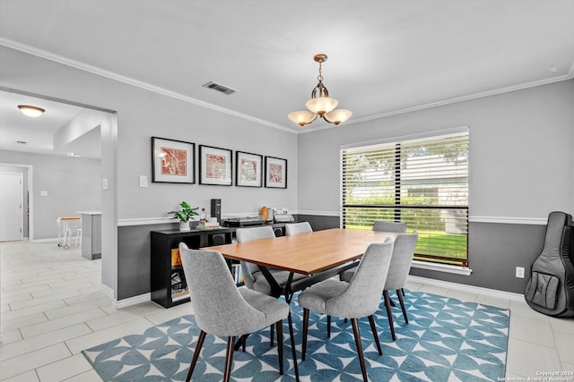 dining area with ornamental molding and an inviting chandelier