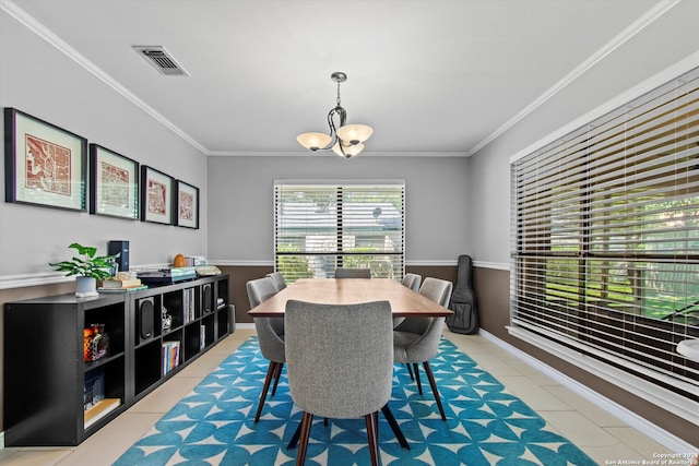 dining space featuring light tile patterned floors, a notable chandelier, and ornamental molding