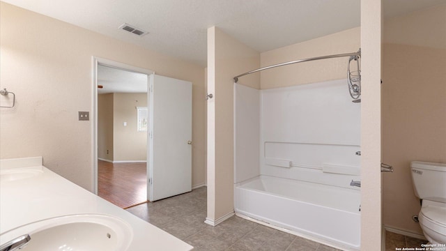 full bathroom with hardwood / wood-style floors, vanity, toilet, and shower / tub combination