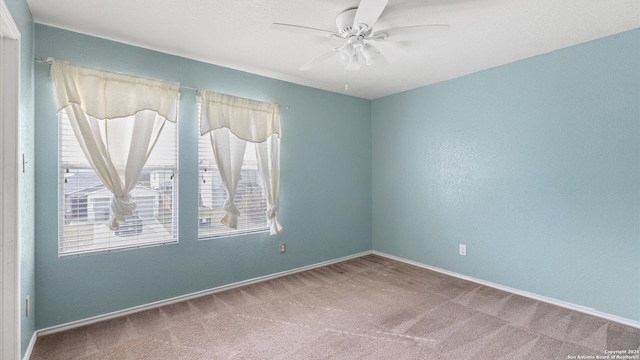 carpeted empty room featuring ceiling fan