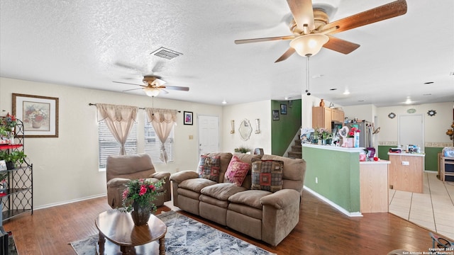 living room with hardwood / wood-style floors and a textured ceiling