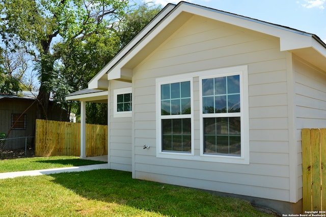 view of property exterior with a lawn