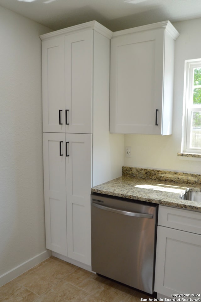 kitchen featuring dishwasher, white cabinetry, and stone counters