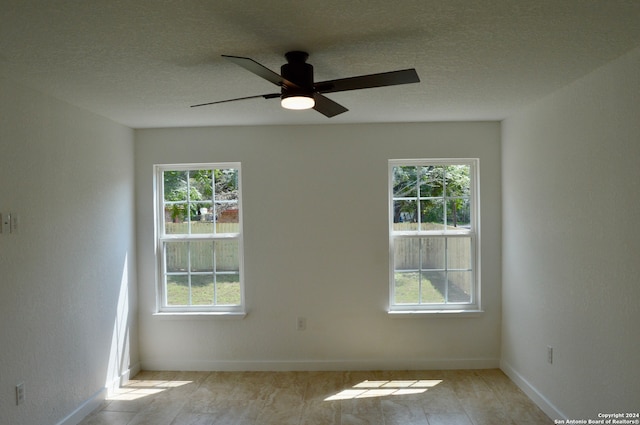 unfurnished room featuring a textured ceiling and ceiling fan