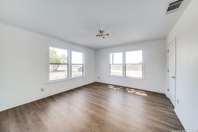 unfurnished room with dark wood-type flooring and a healthy amount of sunlight