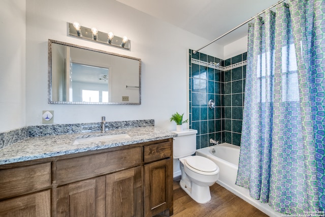 full bathroom featuring vanity, toilet, hardwood / wood-style floors, and shower / bath combo with shower curtain