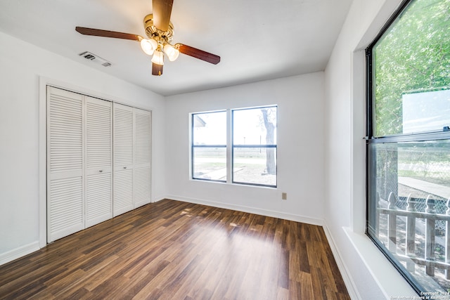 unfurnished bedroom with a closet, ceiling fan, and dark hardwood / wood-style floors