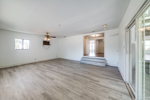 unfurnished living room featuring plenty of natural light, ceiling fan, and light hardwood / wood-style floors