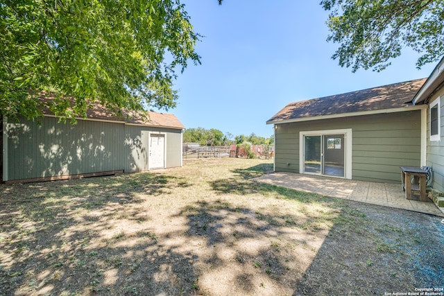 view of yard with an outdoor structure and a patio