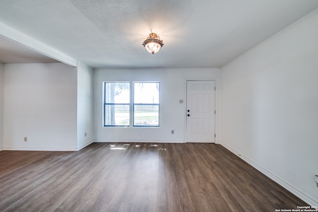 foyer entrance with a textured ceiling and dark hardwood / wood-style flooring