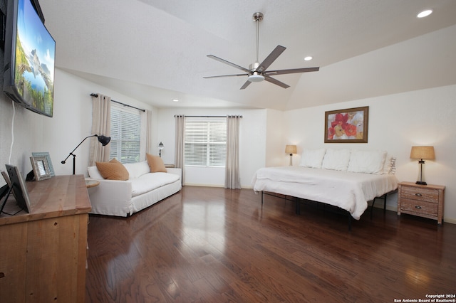 bedroom with ceiling fan, dark hardwood / wood-style floors, and lofted ceiling