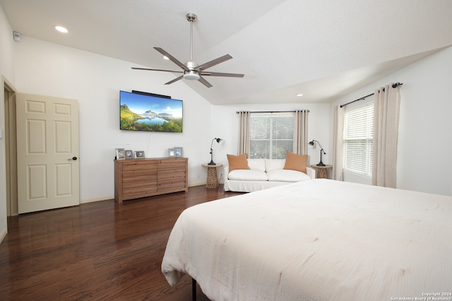 bedroom featuring dark hardwood / wood-style flooring, vaulted ceiling, and ceiling fan