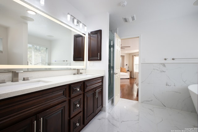 bathroom featuring vanity, wood-type flooring, and a tub