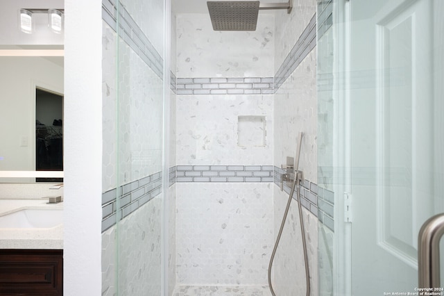 bathroom featuring vanity and a shower with door