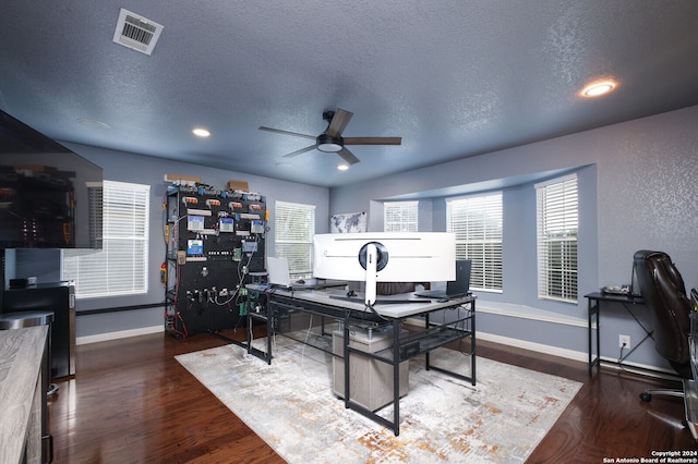 office area featuring dark hardwood / wood-style flooring, a textured ceiling, and ceiling fan