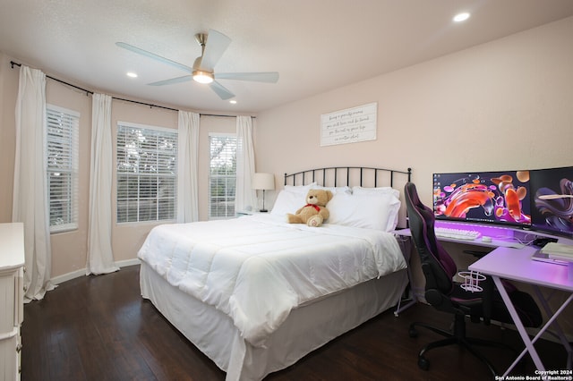 bedroom with ceiling fan and dark hardwood / wood-style floors