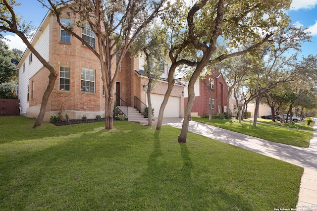 view of front of house featuring a garage and a front yard