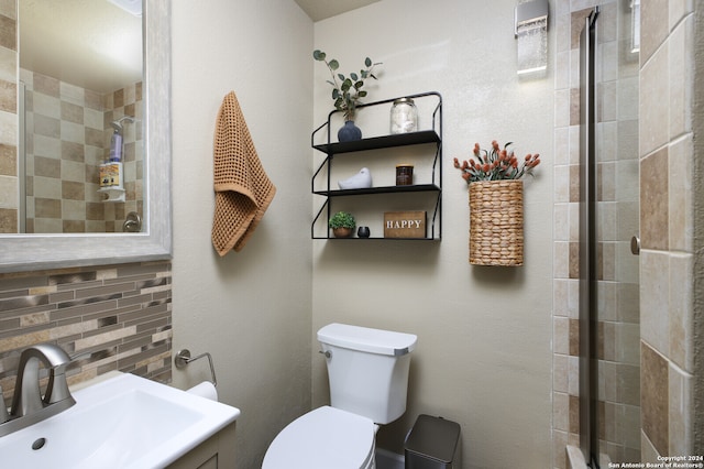 bathroom with sink, an enclosed shower, decorative backsplash, and toilet