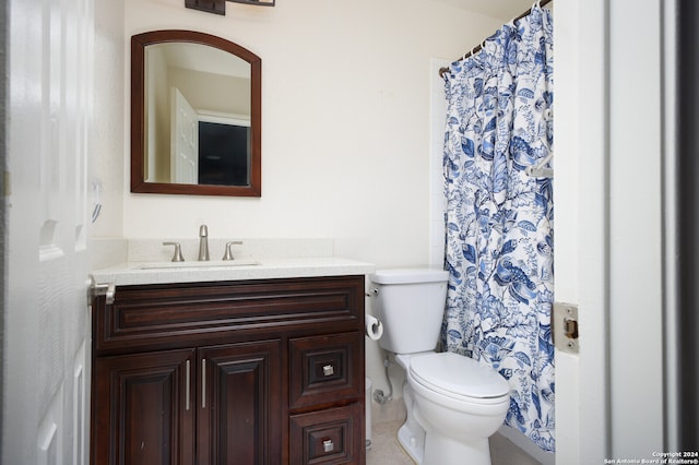 bathroom featuring toilet, vanity, and a shower with shower curtain