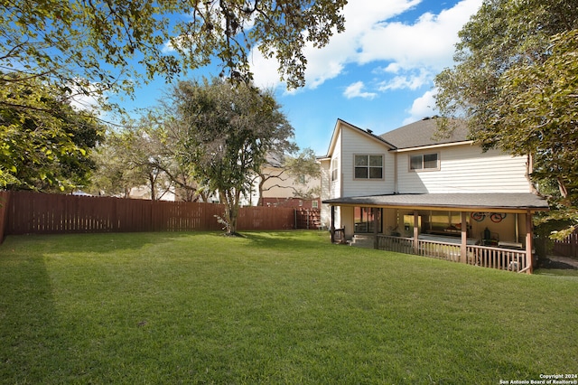 view of yard featuring covered porch