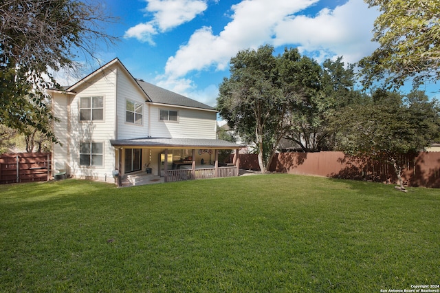 rear view of house with a lawn