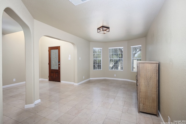 spare room with a textured ceiling