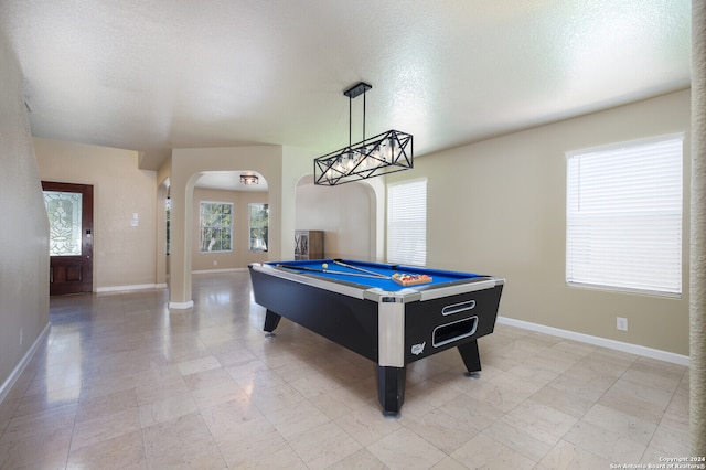 recreation room with billiards, a textured ceiling, and an inviting chandelier