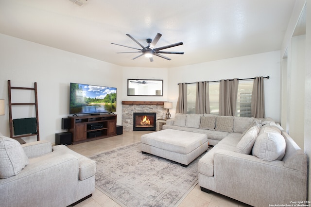 living room featuring a fireplace, ceiling fan, and light tile patterned floors