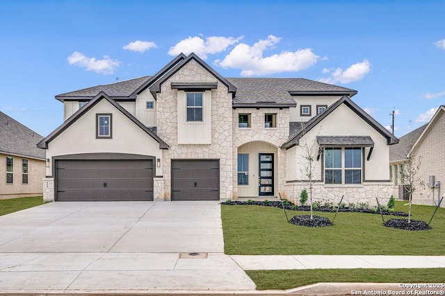 french country style house featuring a front lawn, concrete driveway, roof with shingles, a garage, and stone siding