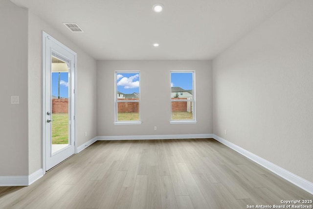 unfurnished room with light wood-type flooring