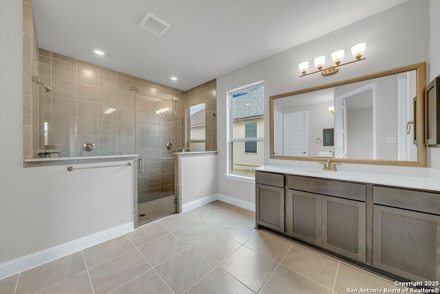 bathroom featuring walk in shower, vanity, and tile patterned flooring