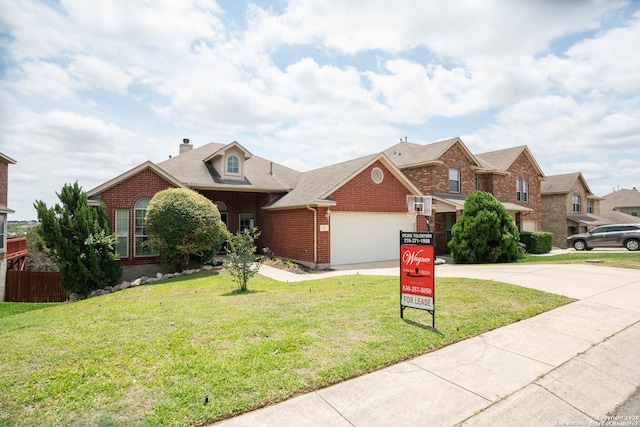 view of front of property with a garage and a front lawn