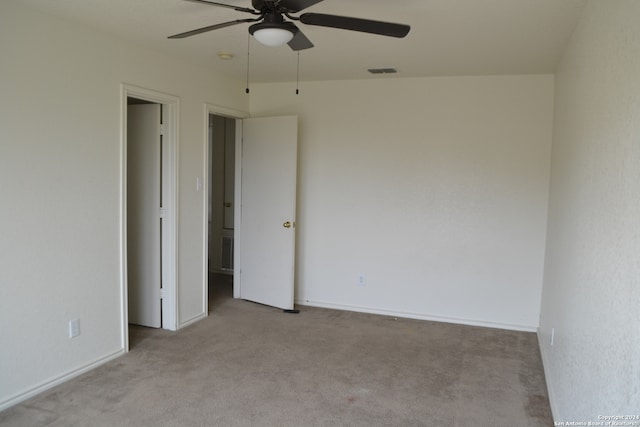 interior space with light carpet and ceiling fan