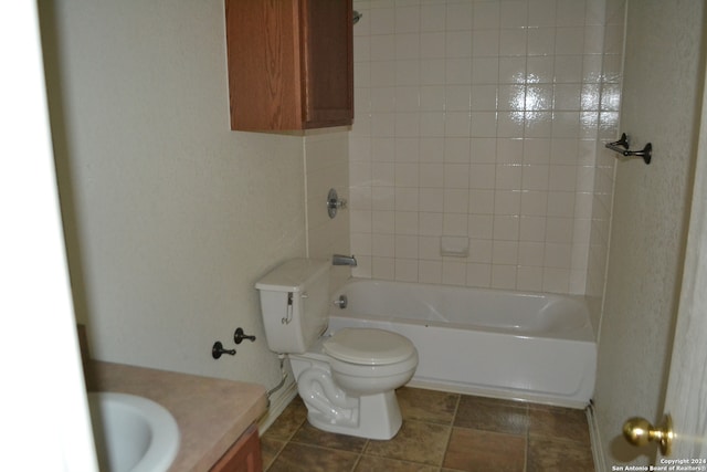 full bathroom featuring tiled shower / bath, vanity, and toilet