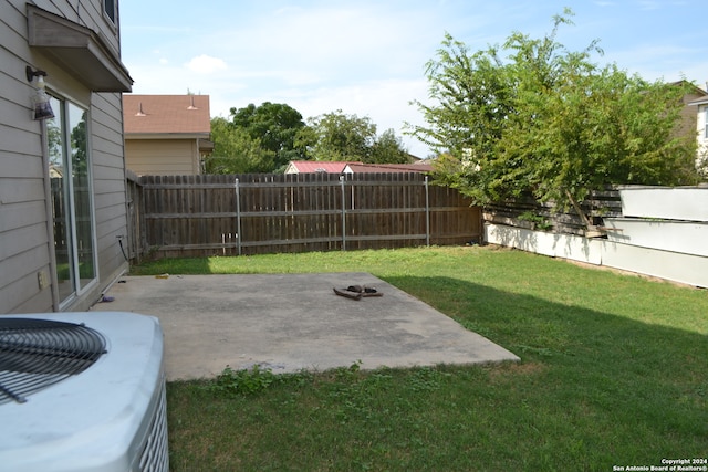 view of yard featuring central AC unit and a patio